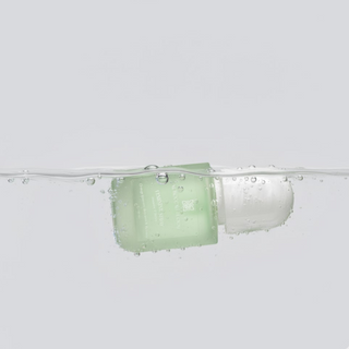 Moroccan Bloom Feminine Spray submerged underwater with rising bubbles, emphasizing the refreshing and hydrating formula of the Orange Blossom and Verbena mist.