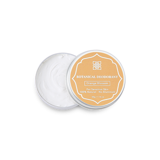 Open tin of Moroccan Bloom Orange Blossom natural deodorant showing the smooth white cream inside the travel-friendly 50g container.