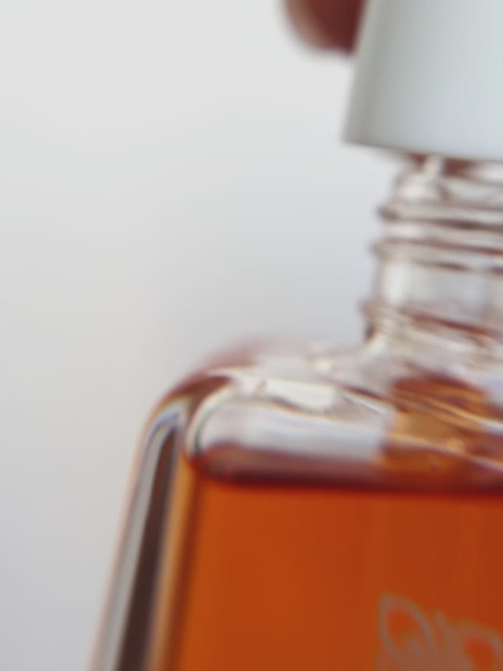Close-up video of The Intimate Care Elixir dropper bottle showing the oil texture