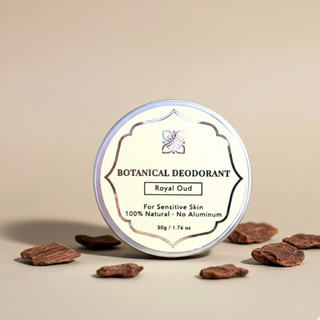 Royal Oud Botanical Deodorant tin for sensitive skin surrounded by natural wood chips on a neutral tan background.